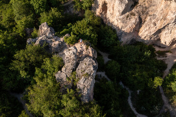 Woman hiking over camel rock in Budapest, adventure concept