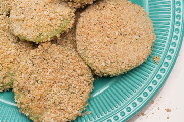 Green tomato slices breaded and ready to go into the frying pan
