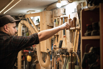Side view of carpenter, professional businessman holding and putting joinery equipment tools in...