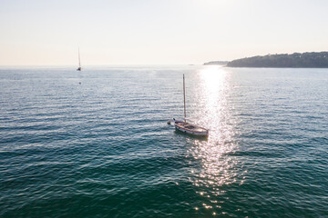 Aerial of Sailing boat in the adriatic sea by Rovinj city before sunset in summer