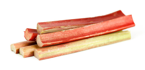 Red stalks of rhubarb on a white background, selective focus.