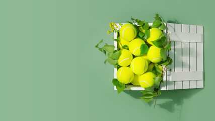 Tennis banner with yellow, tennis balls in a white, wooden box with green branches on a green...