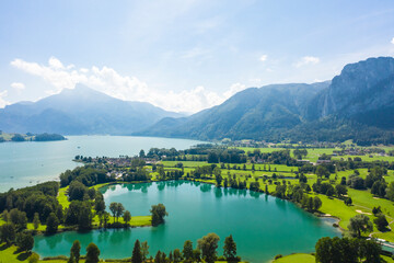 Fototapeta premium Aerial of Mondsee lake and golfing fields, Mondsee, Austria