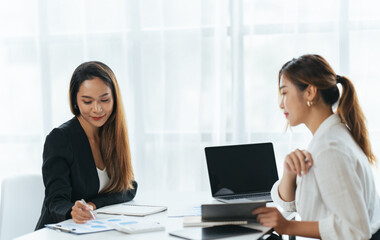 Happy young business colleagues in modern office,Two confident business ladies.