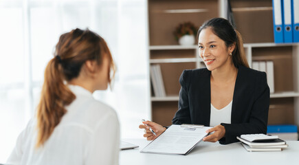 Group Of Businesswomen Collaborating In Creative Meeting Around Table In Modern Office, Female executive putting her ideas during presentation in conference room.