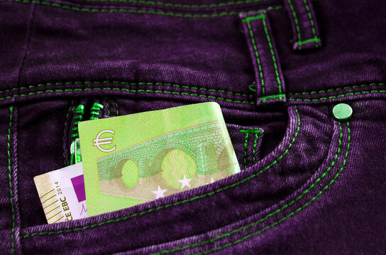 image in neon light, euro money, banknote in jeans pocket