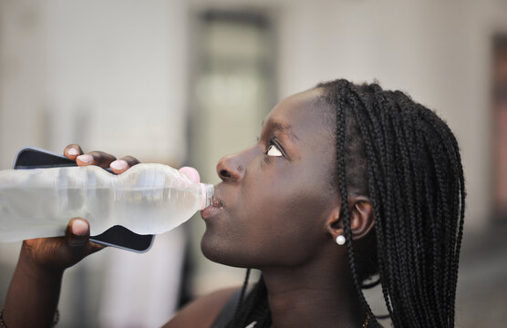 portrait of young woman while drinking water