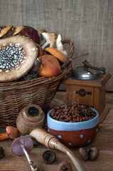 Still life of mushrooms in a basket, and a teapot, and a cup of tea.