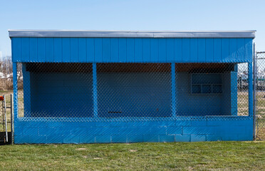 Rural community wooden baseball dugout. Simple sparse. - obrazy, fototapety, plakaty