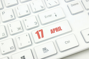 April 17th. Day 17 of month, Calendar date. Cropped view of Modern White Computer Keyboard with...