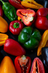 Yellow green red black bell pepper top view food background