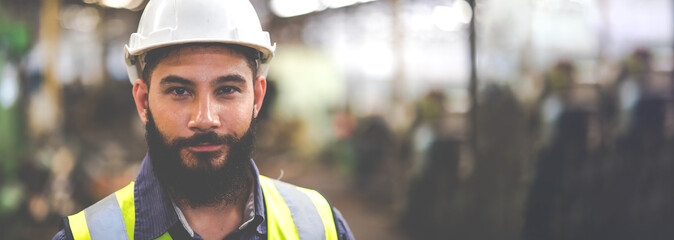 Portrait Professional mechanical engineering hispanic male in white safety hard hat helmet and look...