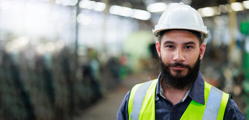 Portrait Professional mechanical engineering hispanic male in white safety hard hat helmet and look...