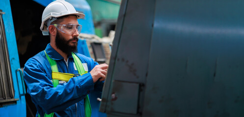 Professional mechanical engineering hispanic male operate lathe machine at metal factory.
