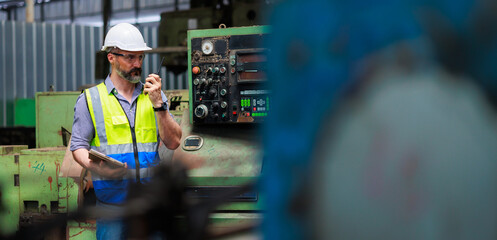 walkie talkie. Portrait Caucasian professional Engineer factory. Engineering worker in safety hardhat at factory industrial facilities. Heavy Industry Manufacturing Factory