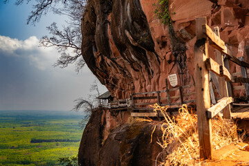 Pathway through the cliff at watphutok, Thailand. The text in photo mean "In this area please remains silent walk in peace"