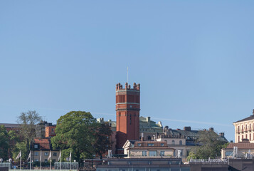 Fototapeta na wymiar Old brick water tower in the district Södermalm a summer day in Stockholm