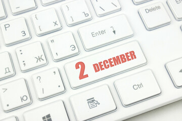 December 2nd. Day 2 of month, Calendar date. Cropped view of Modern White Computer Keyboard with calendar date. Concept workspace, freelance, deadline.  Winter month, day of the year concept.