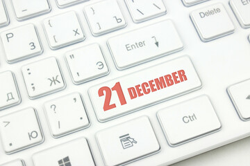 December 21st . Day 21 of month, Calendar date. Cropped view of Modern White Computer Keyboard with calendar date. Concept workspace, freelance, deadline.  Winter month, day of the year concept.