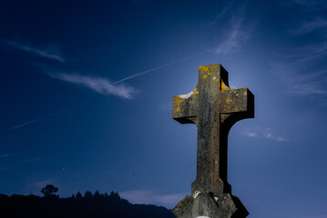 tombs with Christian crosses in a cemetery at night with a full moon. Fear, death and religion. 