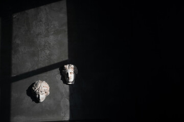 Old retro Loft design room with gray concrete wall and vintage antique bust decoration. Cinematic photo.