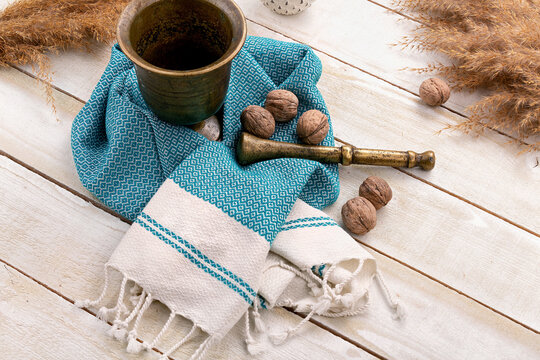 Walnuts, decor towels and antique beater standing on a white wooden table