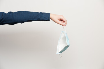 human hand throw out protective medical mask demonstrating complete recovery