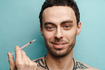 Mid aged brunette man getting facial treatment