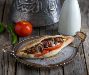 tikka sandwich served in a dish side view on wooden table background