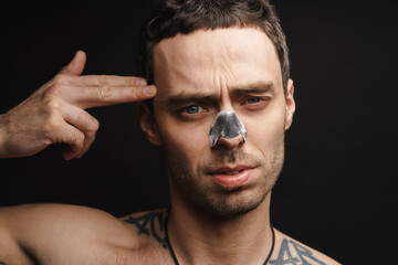 Mid aged white shirtless man using cleansing strip