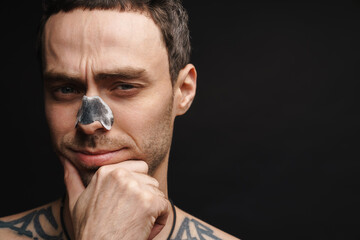 Mid aged white shirtless man using cleansing strip