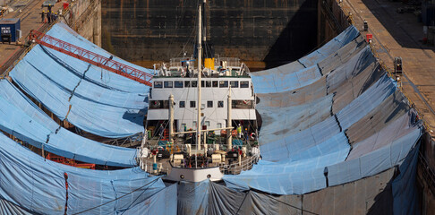 Falmouth, Cornwall, England, UK. 2022.  The historic steamship Shieldhall in dry dock surrounded by...