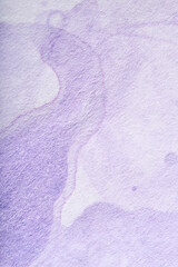 Lilac background, textured paper painted with pastel purple paint in a flowing abstract composition with copy space.