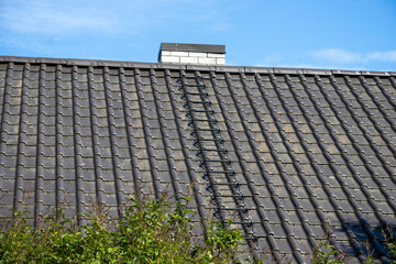Fototapeta na wymiar Metal Roof with laddersand treads. 