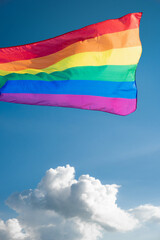 The LGBT flag is developing against the sky. Symbol of equal rights for lesbians, homosexuals, transgender people, bisexuals. Pride month. Rainbow flag