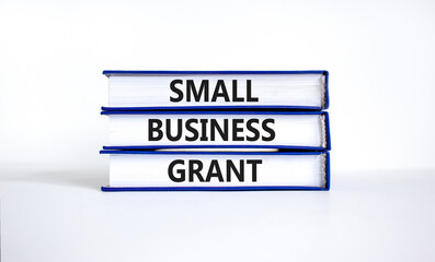 Small business grant symbol. Concept words Small business grant on books on a beautiful white table white background. Business, finacial and small business grant concept.