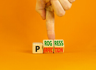 Progress or perfection symbol. Concept words Progress or Perfection on wooden cubes. Businessman...