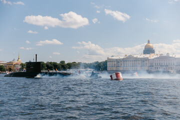 View of the nuclear submarine in the waters of the Neva against the background of St. Isaac's Cathedral. Exhaust fumes and smoke from the boat. Missile submarine. Russia, St. Petersburg, 30.07.2021