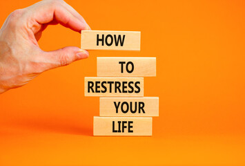 Restress your life symbol. Concept words How to restress your life on wooden blocks. Doctor hand. Beautiful orange background. Psychological business and restress your life concept. Copy space.
