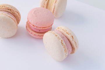 delicious pink macaroons on a white background top view
