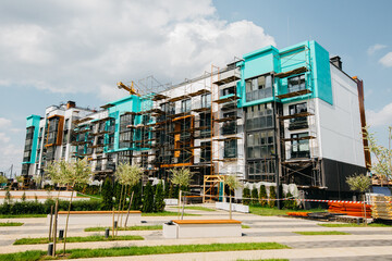 Modern townhouses in a residential area with multiple new apartments buildings