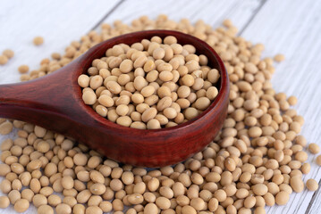 Soybeans on a wood scope white table background