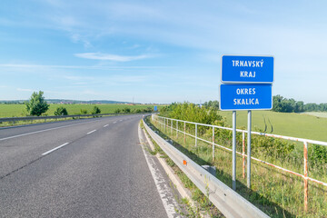 Road with road sign information about Trnava region, Skalica district