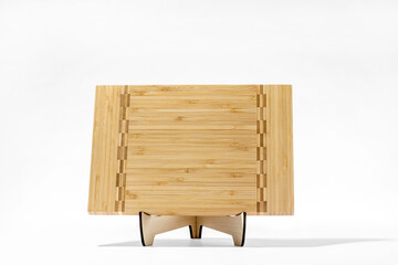 Cutting board on stand on white background