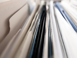 close up view of tightly packed file cabinet contents with muted color, partial focus / soft-focus/...