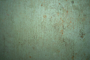Photo of the texture of an old wooden wall painted with green oil paint. Vintage wood background. Wooden texture for text.