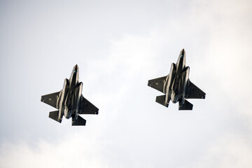 Two american f 35 fighter jets training up in the sky. Defense and war concept.