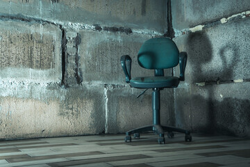 The interrogation chair. An old chair in a concrete basement.