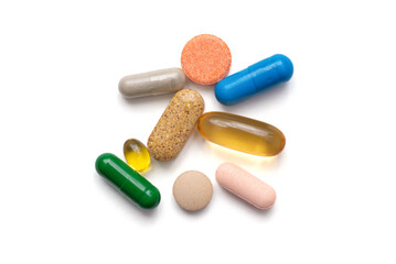colored pills and vitamins on a white background