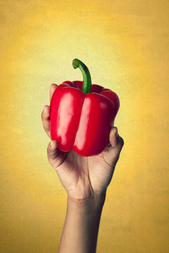 Healthy: Holding a Whole Red Pepper